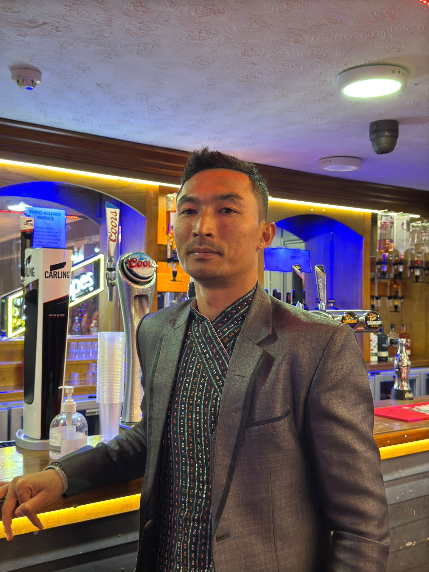 Sajan Dangol in a grey blazer at a celebration event