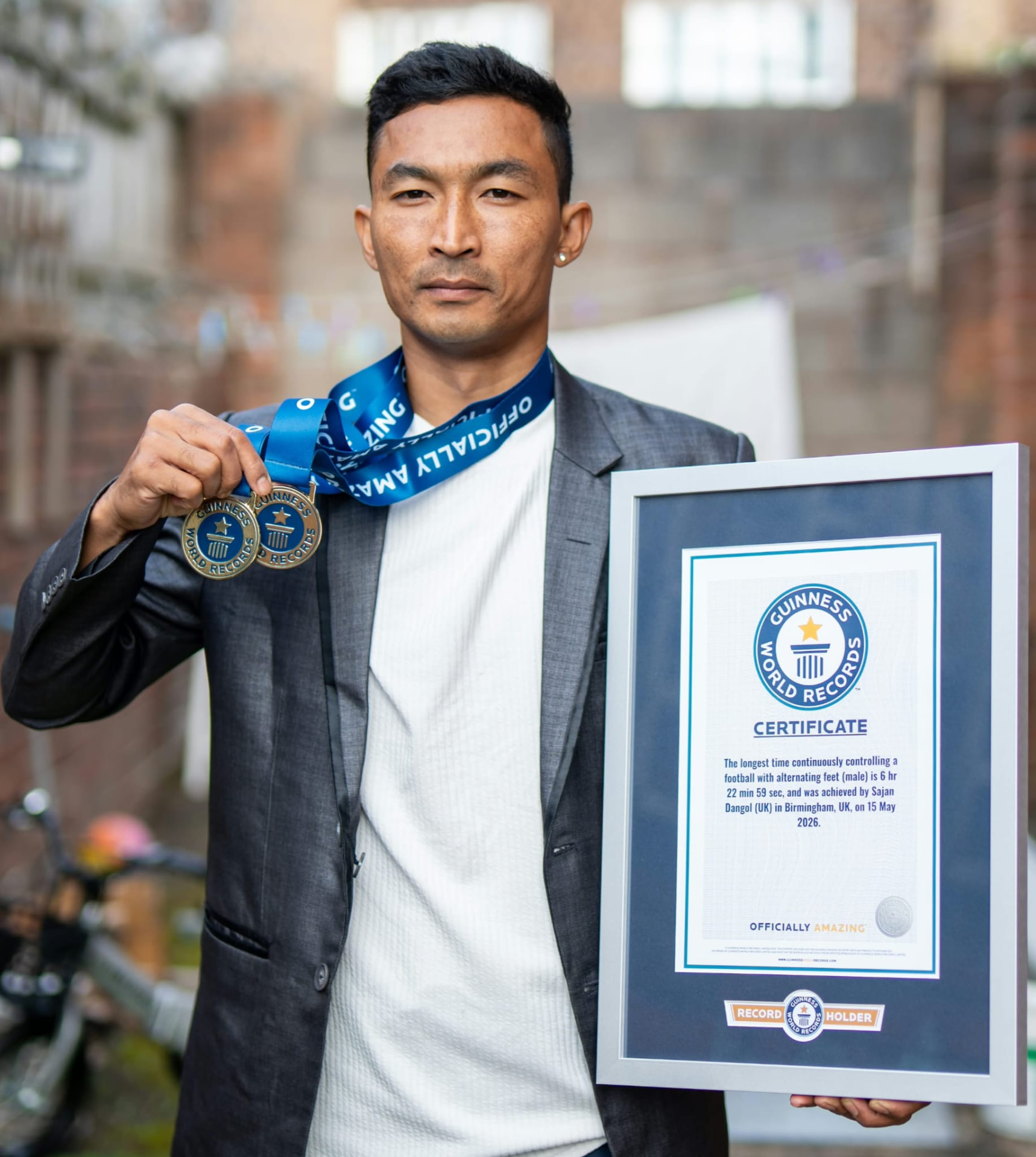 Sajan Dangol holding Guinness World Records medals and his 2026 certificate