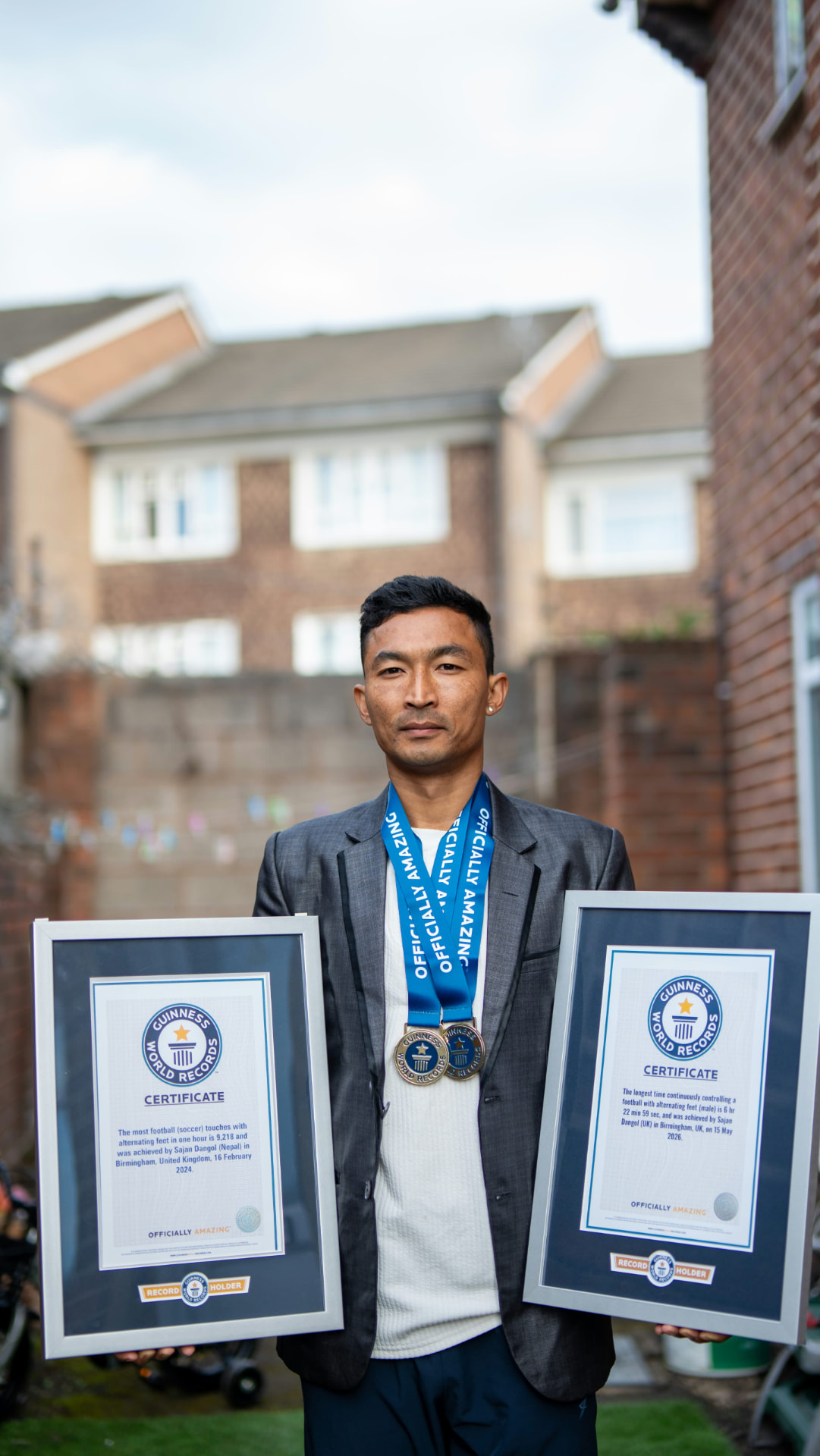 Sajan Dangol holding two Guinness World Records certificates