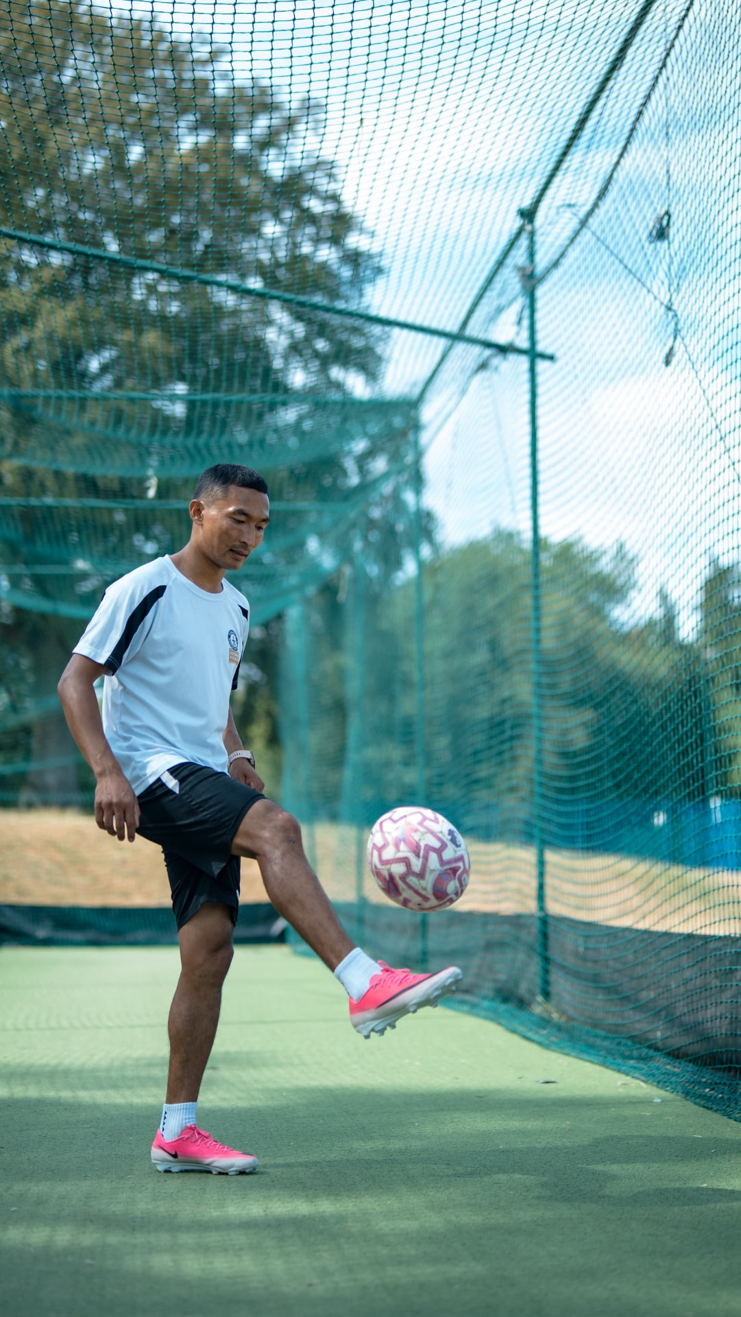 Sajan Dangol juggling a football in a training cage