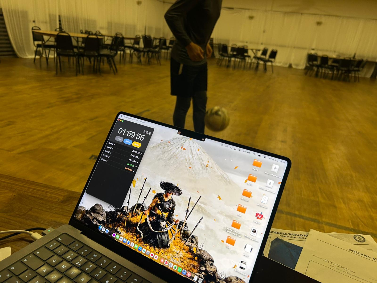 A stopwatch recording a training round while Sajan juggles a football